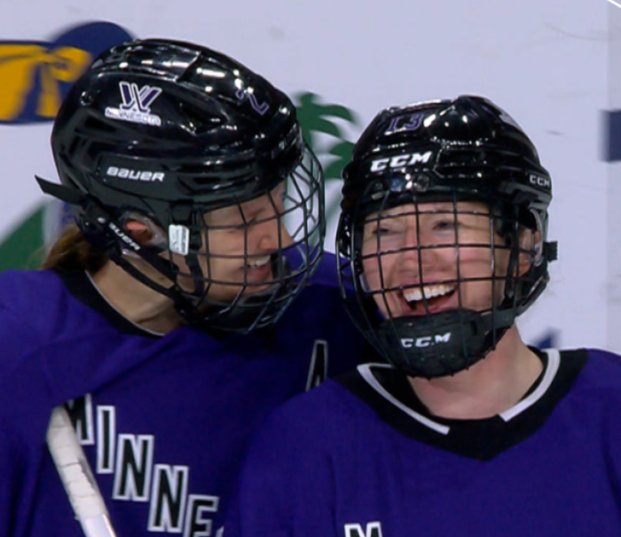 Carlson alum Grace Zumwinkle with teammate during hockey game.